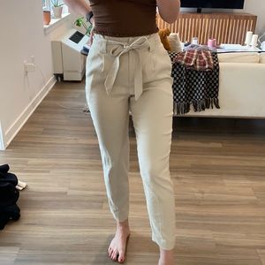Beige/tan paper bag style fitted trousers. Cropped length